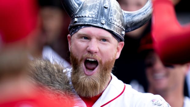 Cincinnati Reds left fielder Jake Fraley (27) smiles as he high fives teammates after hitting a solo home run in the sixth inning of the Baseball game between the Cincinnati Reds and the Arizona Diamondbacks at Great American Ball Park in Cincinnati on Saturday, July 22, 2023. 